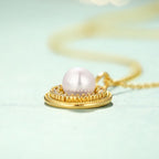 Origsoul freshwater pearl necklace with gold pendant and intricate detailing on delicate chain