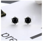Origsoul cosmic star stud earrings with black gemstone center in silver star-shaped setting
