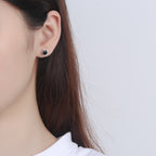 Origsoul cosmic jewelry black gemstone star stud earrings on model ear