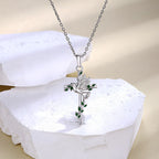 Origsoul dove and cross pendant necklace with silver chain and green leaf details
