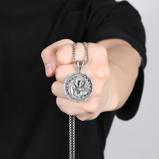 Origsoul silver dragon pendant necklace held in hand with intricate animal jewelry design