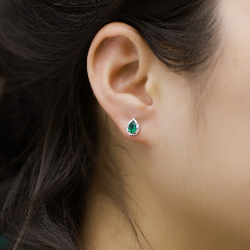 Origsoul silver earrings sterling with green teardrop gemstone worn on ear