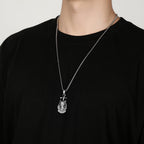 Origsoul Egyptian cat necklace in silver worn on a chain over a black shirt