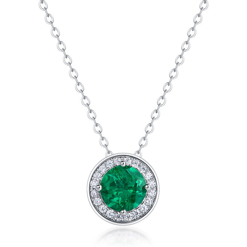 Origsoul emerald necklace with round green gemstone surrounded by small clear crystals on silver chain