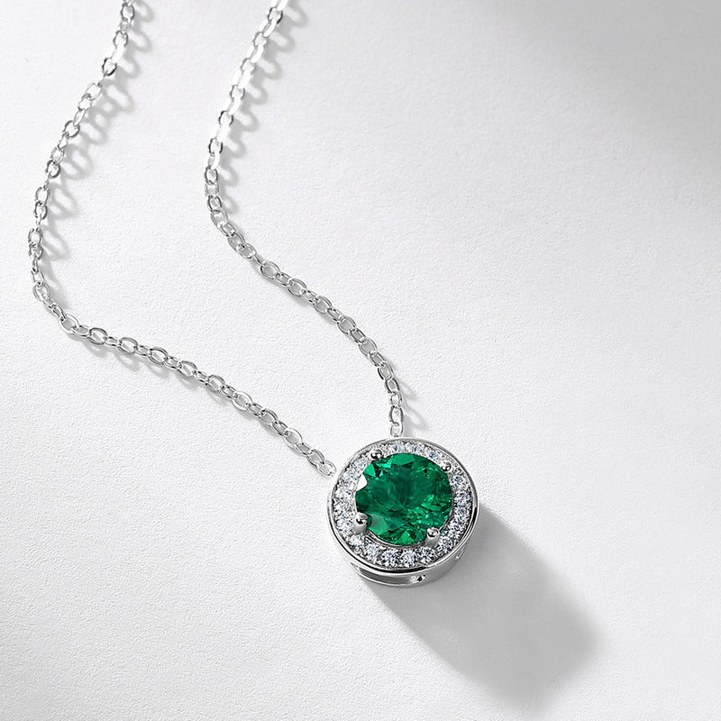 Origsoul emerald necklace with round green gemstone surrounded by white crystals on silver chain