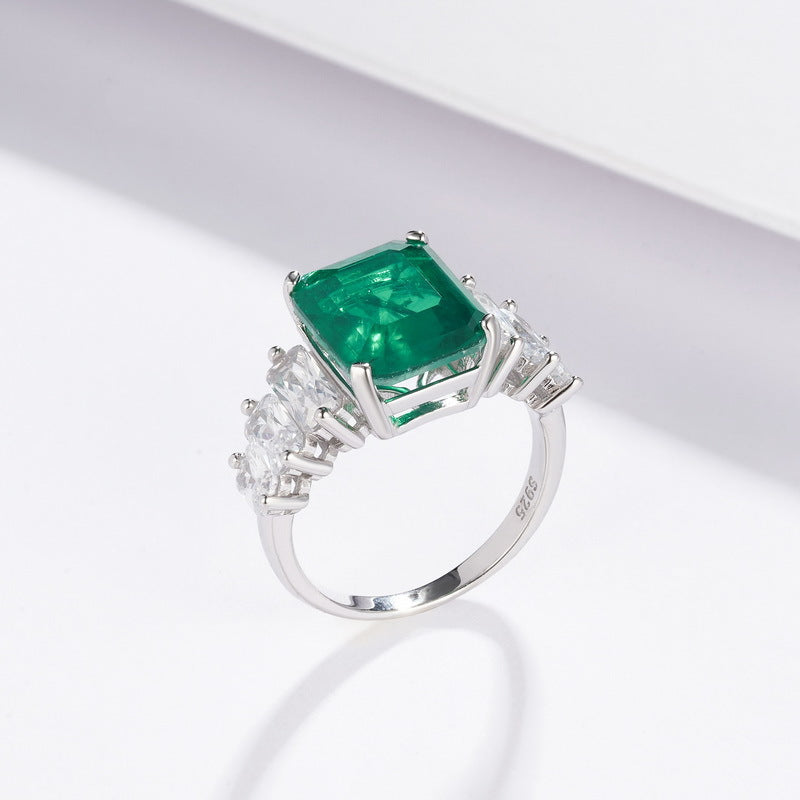 Origsoul engagement ring emerald cut with a large green emerald center stone and side diamonds on silver band