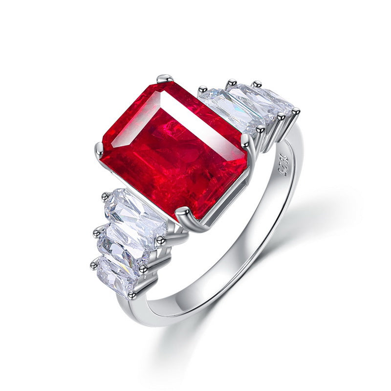 Origsoul engagement ring emerald cut with large red center stone and side white gemstones in silver band