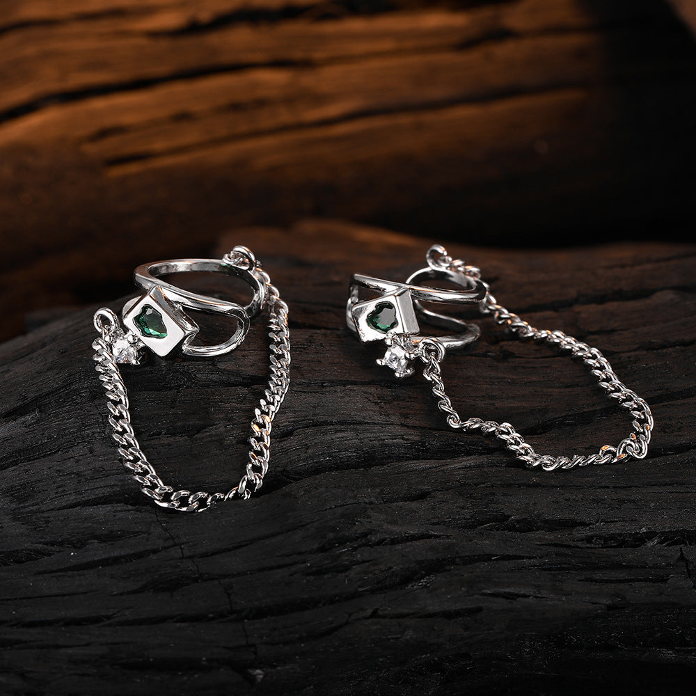Origsoul silver geometric chain drop earrings with green gemstone detail on dark wood background