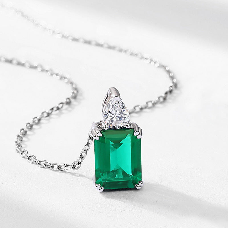 Origsoul pendant with emerald green rectangular gemstone and clear triangular accent on silver chain