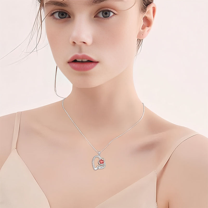 Origsoul silver rose heart pendant necklace worn by woman with light skin and neutral top
