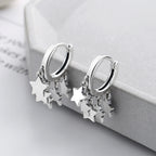 Origsoul silver star tassel hoop earrings from Cosmic Jewelry with dangling star charms