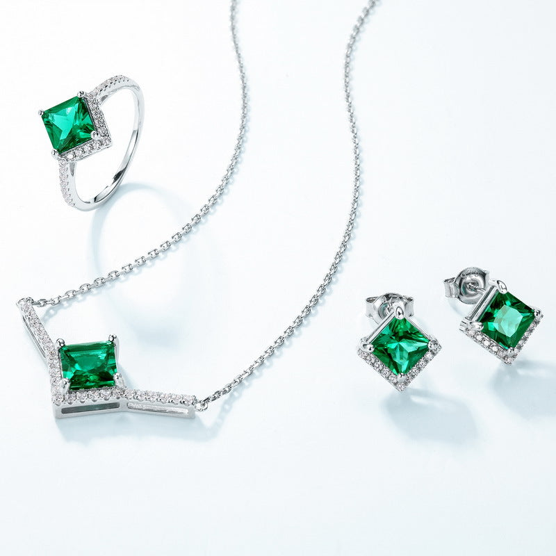Origsoul silver sterling ring with green square gemstone alongside matching necklace and earrings set