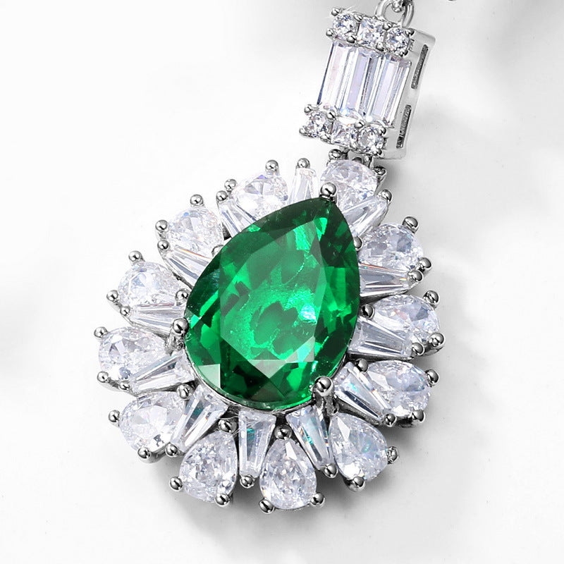 Origsoul silver sterling silver earrings with large green teardrop gem surrounded by clear crystals