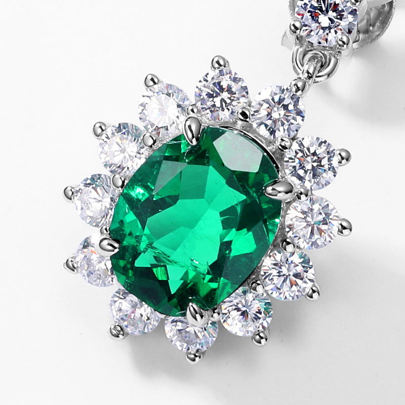 Origsoul silver sterling silver earrings featuring a large green gemstone surrounded by sparkling clear crystals
