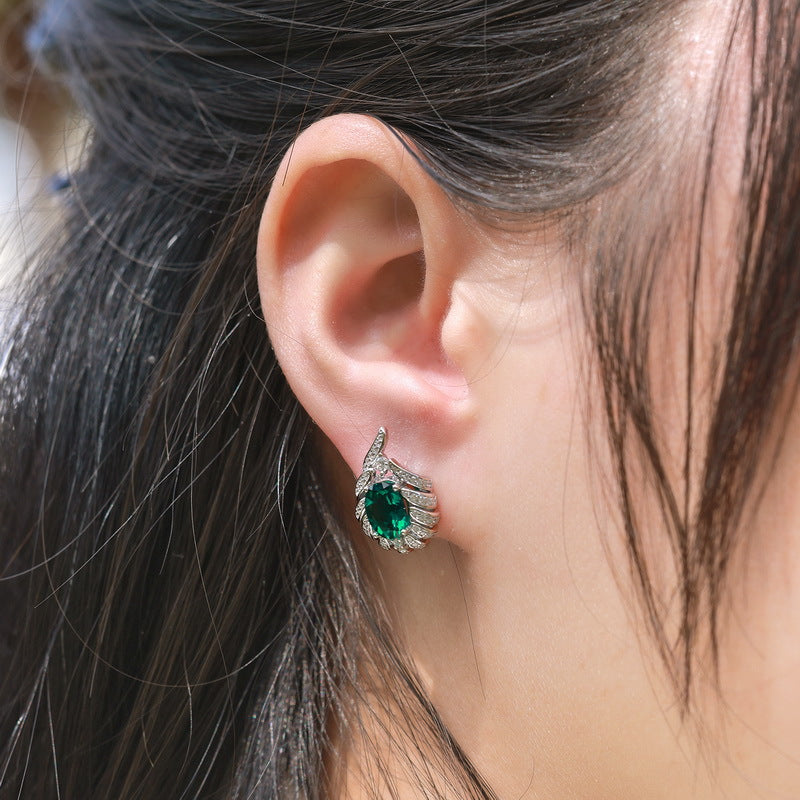 Origsoul silver sterling silver earrings featuring a green gemstone and intricate design worn on ear