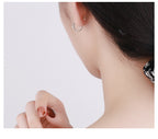 Origsoul silver wheat hoop earrings worn on ear with close-up view of textured design