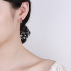 Origsoul silver wheat hoop earrings worn on ear with a subtle woven design