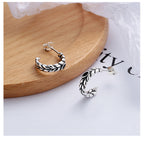 Origsoul silver wheat hoop earrings featuring detailed woven design on a wooden surface