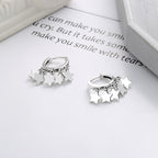 Origsoul star tassel hoop earrings in silver with five dangling star charms on each hoop