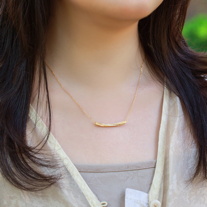 Origsoul sterling necklace silver worn by woman with simple gold bar pendant on thin chain