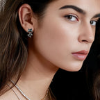 Origsoul silver cat face earrings worn by woman with layered necklaces and dark hair