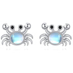Origsoul sterling silver crab earrings with sparkling blue center stone and intricate detailing
