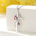 Sterling silver cross ladybug necklace featuring intricate design and a sparkling accent