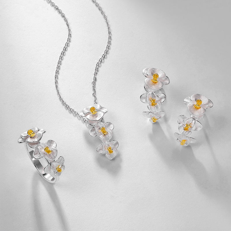 Origsoul sterling silver earrings and matching ring with delicate flower design and yellow centers