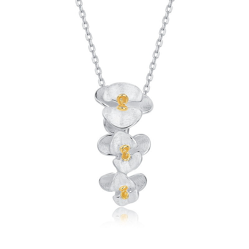 Origsoul sterling silver earrings with floral design and gold-tone accents on a delicate chain