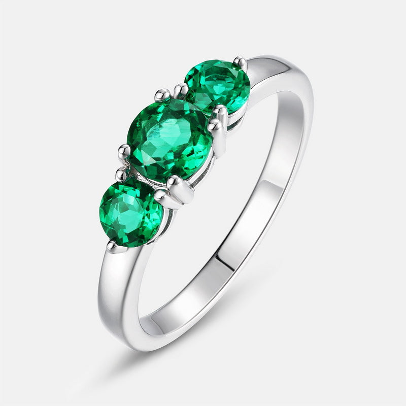 Origsoul engagement ring emerald cut with three vibrant green emerald stones set on a silver band