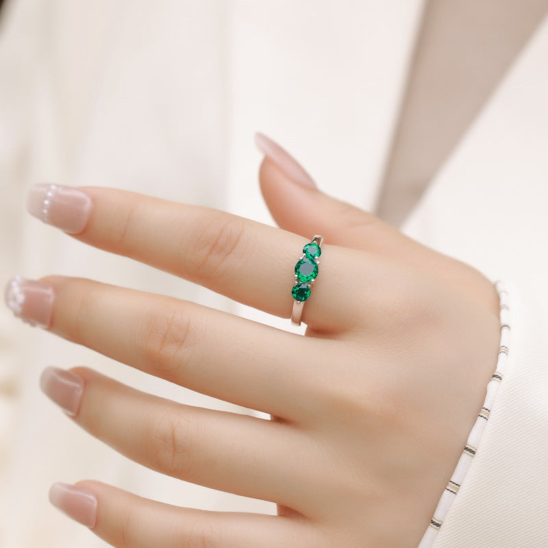 Origsoul engagement ring emerald cut with three vibrant green emerald stones on silver band