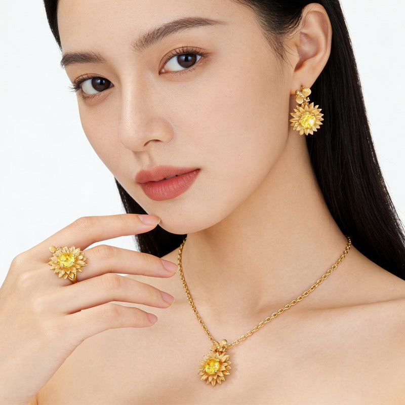 Origsoul sterling silver jelwery sunflower gold-tone necklace earrings and ring set worn by woman