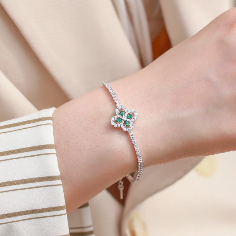 Origsoul sterling silver jelwery bracelet with green gemstone flower design on wrist