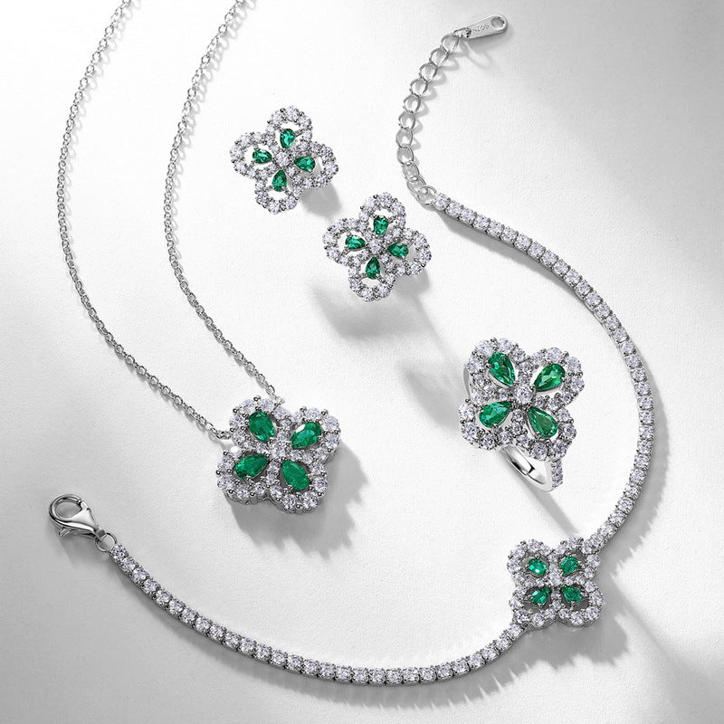 Sterling silver jelwery set by Origsoul with green gemstones and clear crystals including necklace earrings ring and bracelet