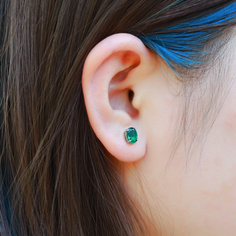 Origsoul sterling silver jewerly emerald green stud earring on ear with blue hair strand