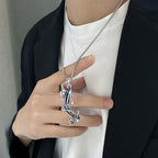 Stylish sterling silver killer whale necklace worn by a person, showcasing intricate design and elegance