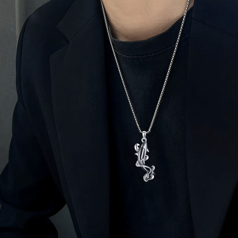 Origsoul sterling silver killer whale necklace hanging from a stylish chain worn by a model
