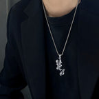 Origsoul sterling silver killer whale necklace hanging from a stylish chain worn by a model