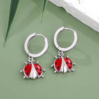 Sterling silver ladybug earrings with red enamel detailing and hoop design