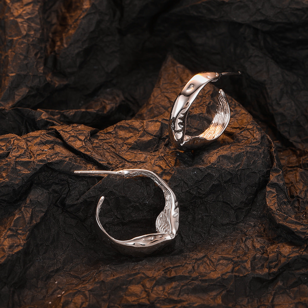 Origsoul modern bumpy hoop earrings in silver with unique textured design on black fabric
