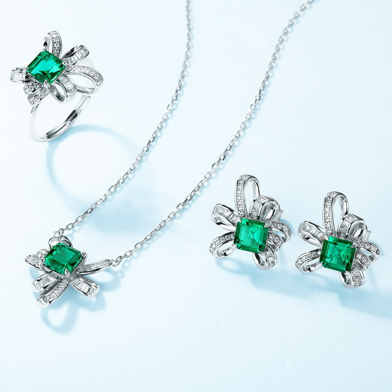 Origsoul sterling silver necklace and matching ring and earrings set with green square gemstones and decorative ribbon design