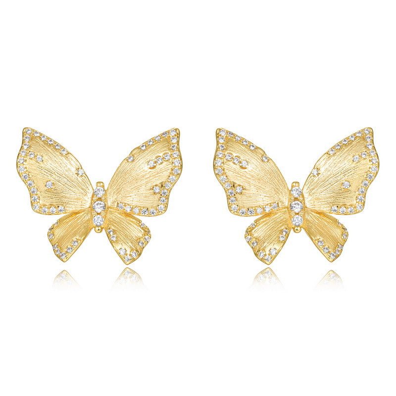 Origsoul gold butterfly stud earrings with crystal accents complementing sterling silver necklace
