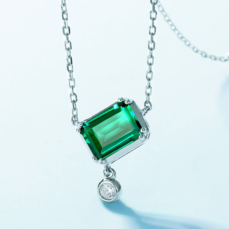 Origsoul sterling silver necklace with a rectangular green gemstone and a small round clear pendant