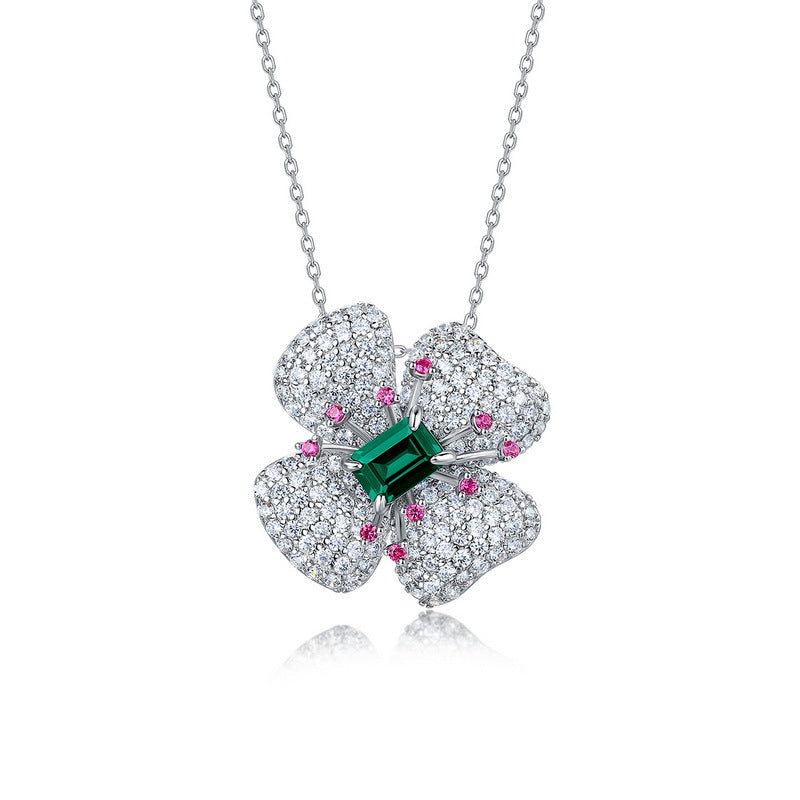 Origsoul sterling silver necklace with a four-petal flower pendant featuring a green center stone and small pink and white accents