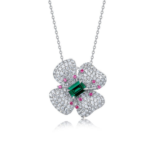 Origsoul sterling silver necklace with a four-petal flower pendant featuring a green center stone and small pink and white accents