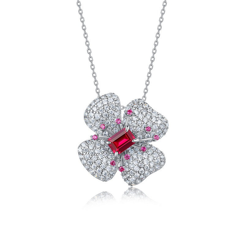 Origsoul sterling silver necklace with a flower pendant adorned with clear and red gemstones
