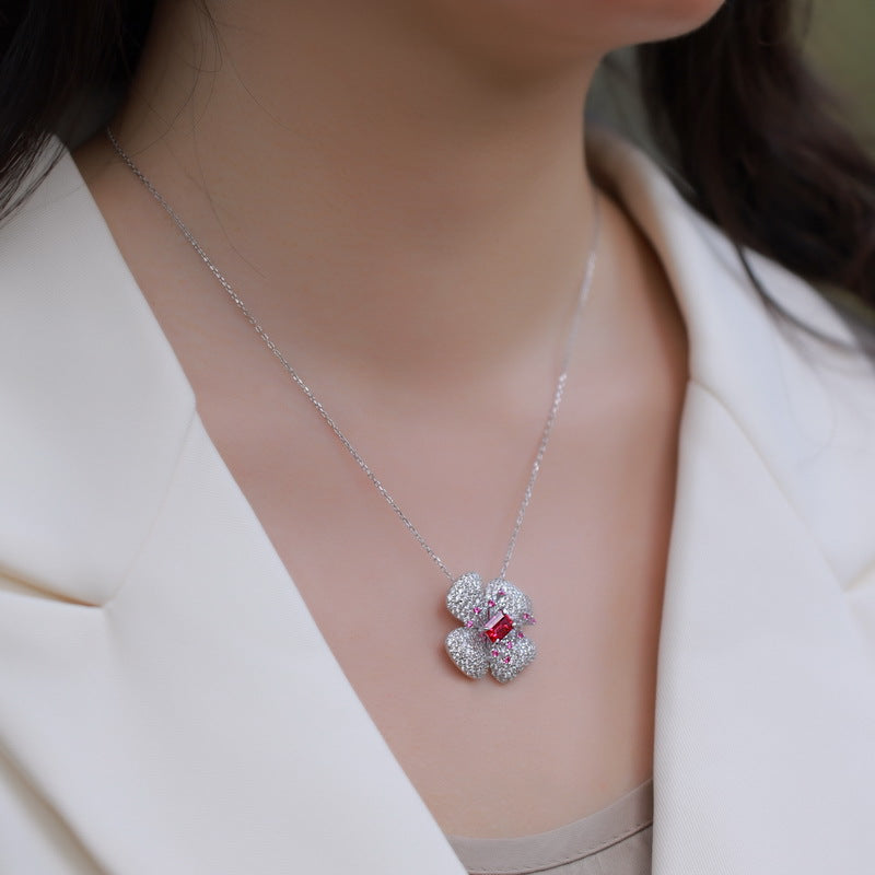 Origsoul sterling silver necklace with sparkling floral pendant worn with white blazer