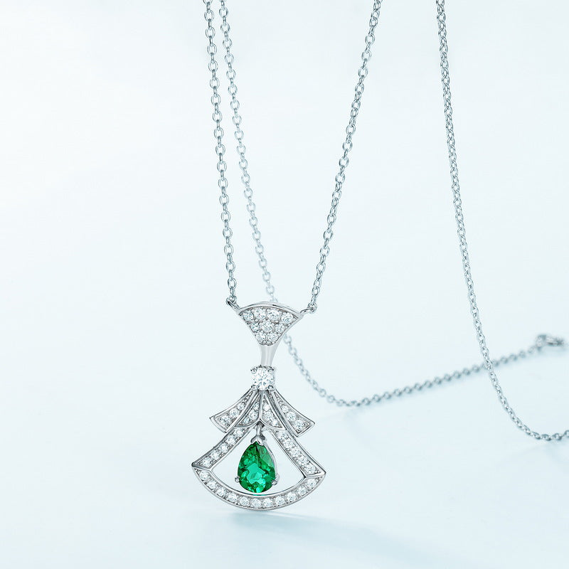 Origsoul sterling silver necklace with an elegant fan-shaped pendant featuring a green gemstone and small clear stones