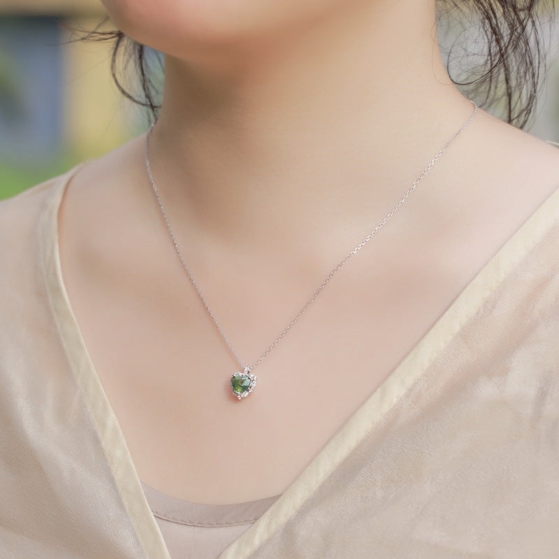 Origsoul sterling silver necklace with green gemstone pendant worn on a woman’s neck