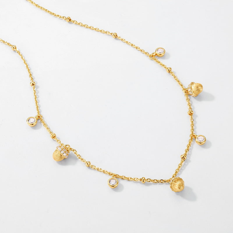 Origsoul necklace in sterling silver with gold-tone acorn charms and clear crystal accents